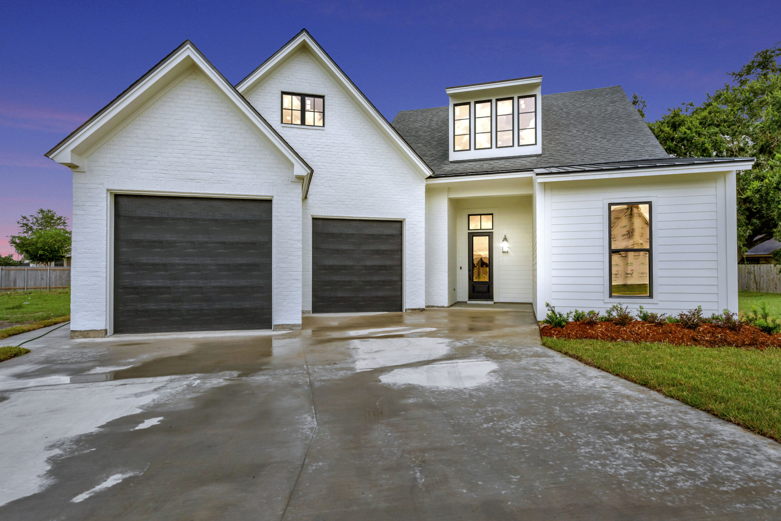 Creole Belle at twilight, a custom home by Prestigious Home Builders in Green Farms